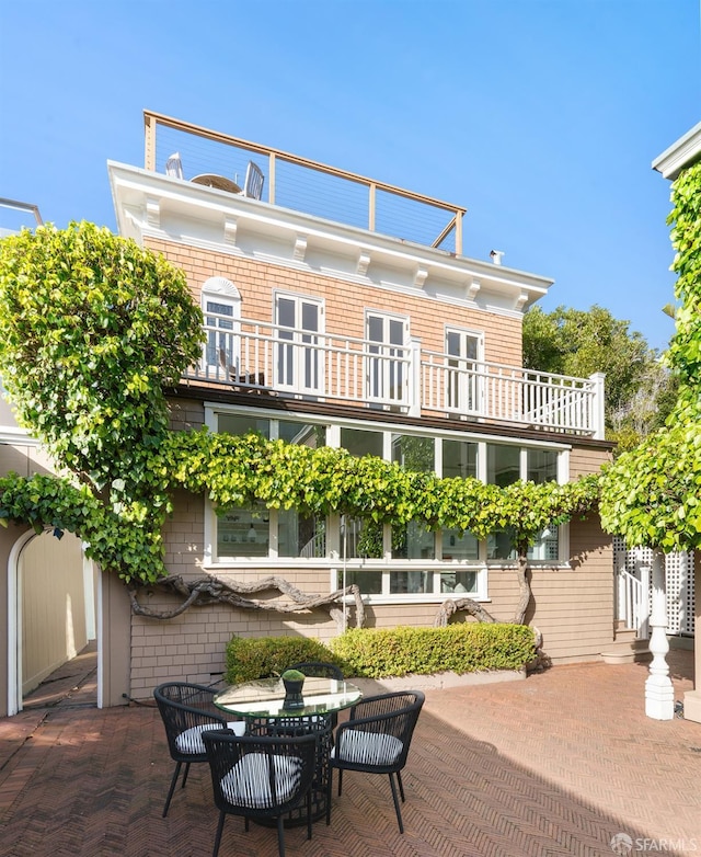 back of house with a patio area and a balcony