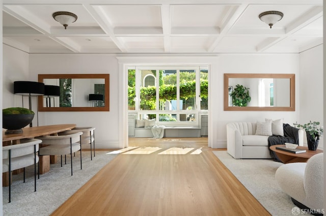 interior space with coffered ceiling, wood finished floors, beam ceiling, and baseboards