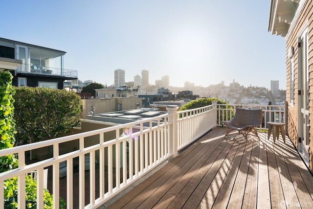 wooden deck with a city view