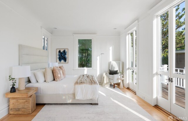 bedroom featuring french doors and wood finished floors