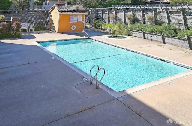 view of swimming pool featuring a pergola and a patio