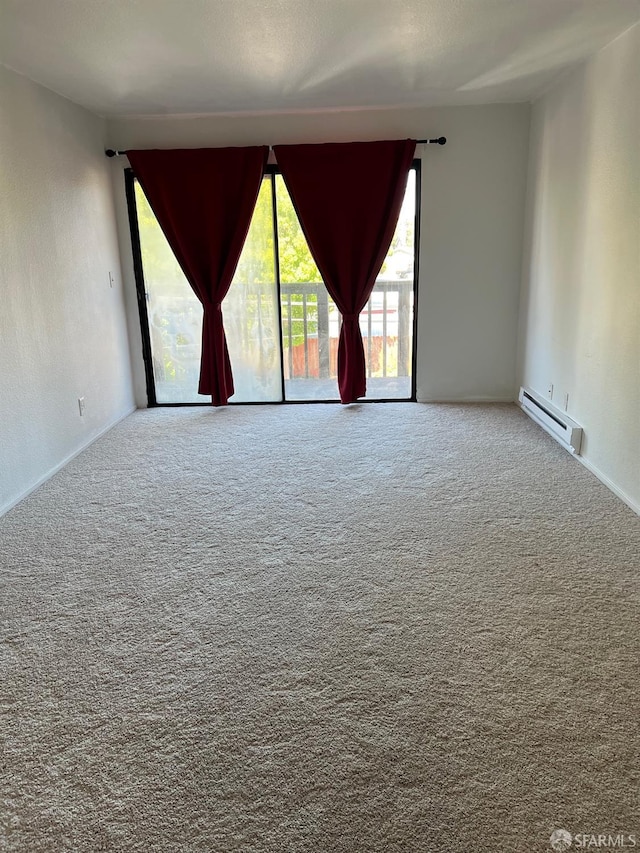 carpeted empty room with a baseboard radiator