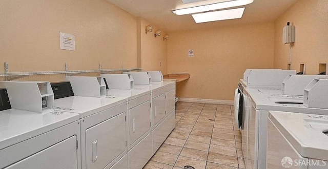 laundry area featuring washer and dryer and light tile patterned flooring