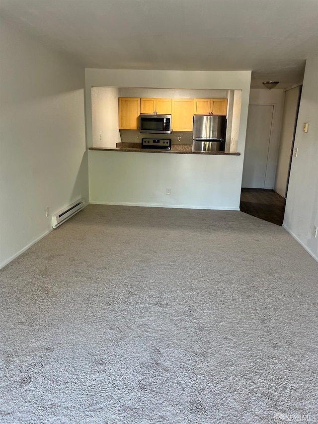 unfurnished living room with dark colored carpet and a baseboard radiator