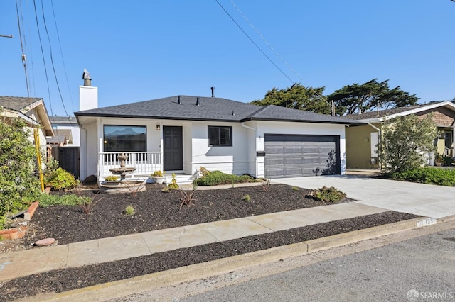 ranch-style home with a garage, driveway, a shingled roof, and stucco siding