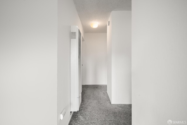 1919 Ygnacio Valley Rd Unit 33, Walnut Creek, CA 94598 - corridor with carpet floors, a textured ceiling, a heating unit, and baseboards