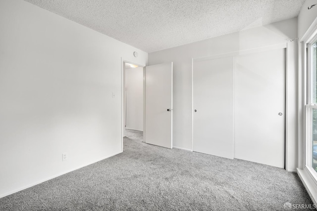 1919 Ygnacio Valley Rd Unit 33, Walnut Creek, CA 94598 - unfurnished bedroom featuring carpet, a textured ceiling, and a closet