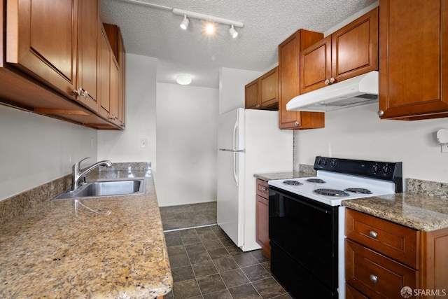 1919 Ygnacio Valley Rd Unit 33, Walnut Creek, CA 94598 - kitchen featuring electric stove, under cabinet range hood, a sink, brown cabinetry, and freestanding refrigerator