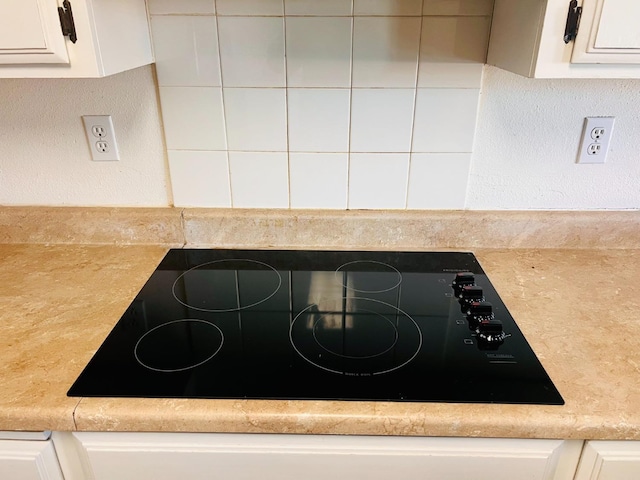 details featuring white cabinetry and black electric cooktop