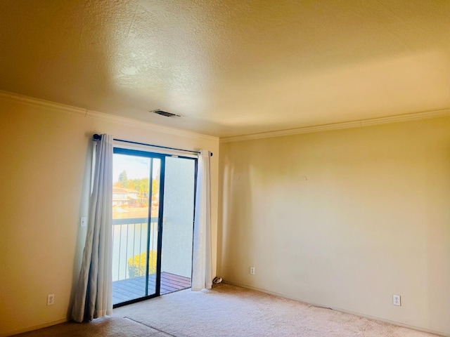 carpeted empty room with a textured ceiling and ornamental molding