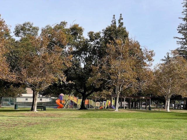 view of community featuring a playground and a yard