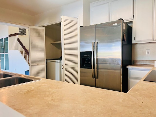 kitchen featuring white cabinetry, black electric stovetop, and stainless steel fridge with ice dispenser