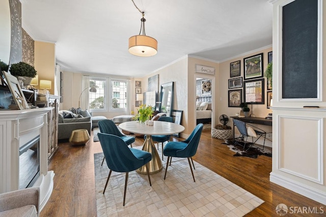 dining area featuring crown molding and hardwood / wood-style flooring