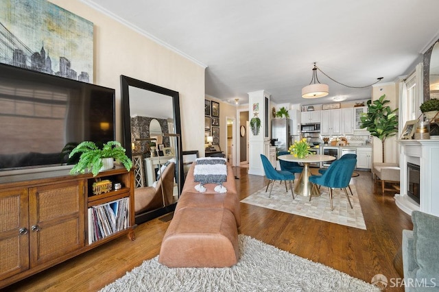 dining space featuring ornamental molding and dark hardwood / wood-style floors