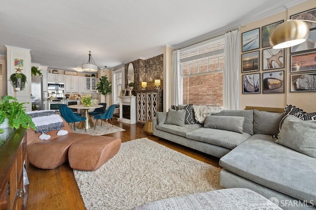 living room with dark hardwood / wood-style flooring and ornamental molding