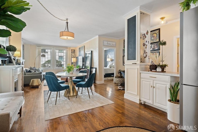 dining room featuring dark hardwood / wood-style flooring and crown molding