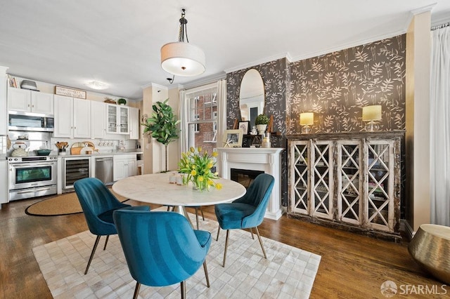 dining space with ornamental molding, wine cooler, and dark hardwood / wood-style floors