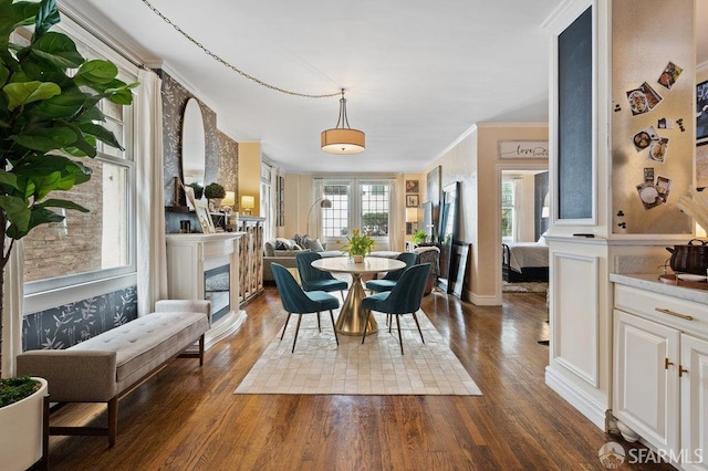 dining room featuring dark hardwood / wood-style floors and crown molding