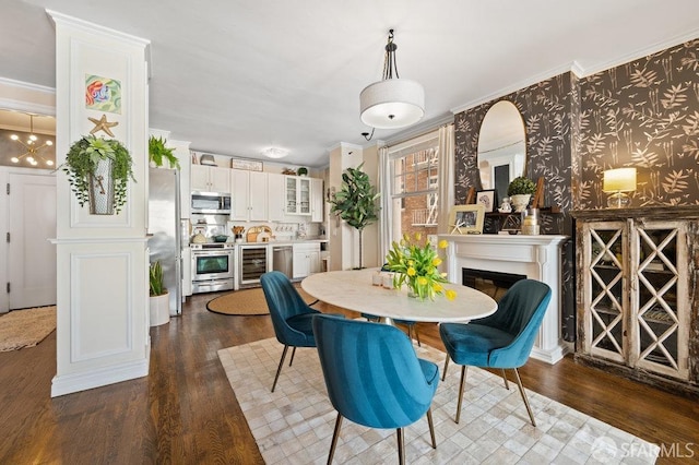 dining area with dark wood-type flooring, crown molding, and wine cooler