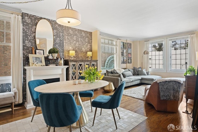 dining space with crown molding and wood-type flooring