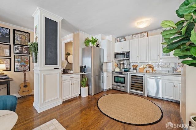 kitchen featuring stainless steel appliances, wine cooler, and white cabinets