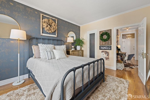 bedroom with ornamental molding and wood-type flooring