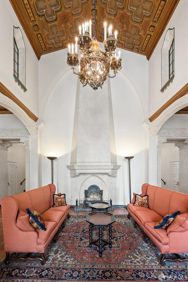 living room featuring a notable chandelier, brick ceiling, a large fireplace, and high vaulted ceiling