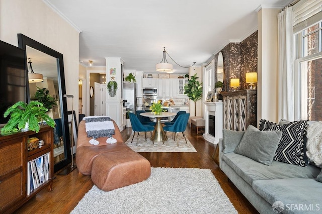 living room with dark hardwood / wood-style flooring and crown molding