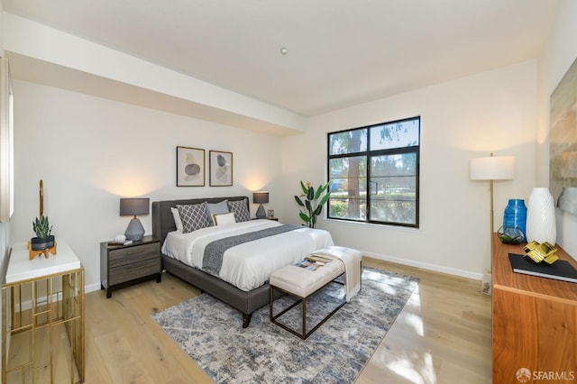 bedroom featuring light wood-type flooring and baseboards