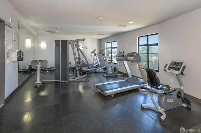 exercise room with recessed lighting, visible vents, and baseboards