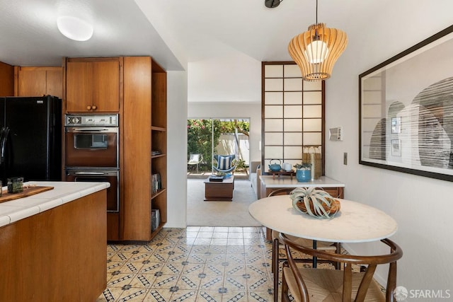 2691 Sean Ct, South San Francisco, CA 94080 - kitchen featuring freestanding refrigerator, tile countertops, multiple ovens, brown cabinetry, and pendant lighting