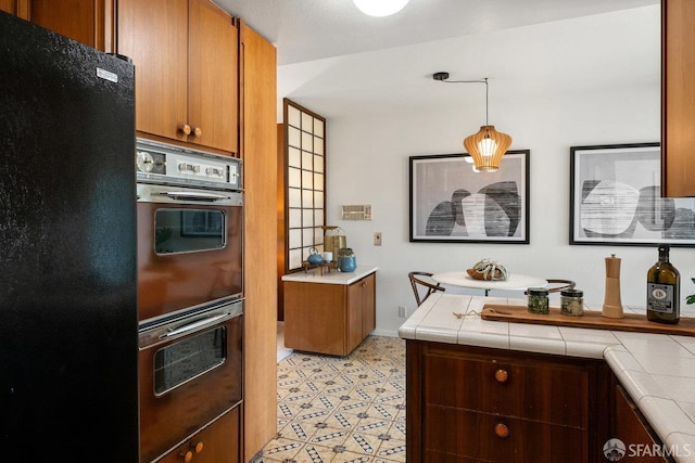 2691 Sean Ct, South San Francisco, CA 94080 - kitchen with double wall oven, tile counters, freestanding refrigerator, and brown cabinets