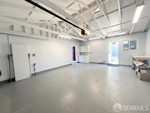 2691 Sean Ct, South San Francisco, CA 94080 - garage featuring a garage door opener and baseboards