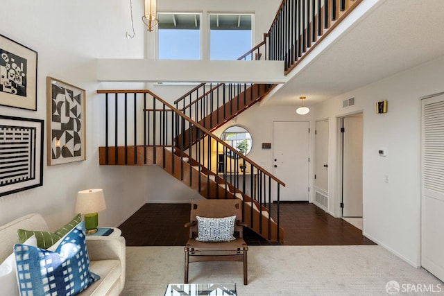 2691 Sean Ct, South San Francisco, CA 94080 - carpeted living room with stairs, healthy amount of natural light, a high ceiling, and baseboards