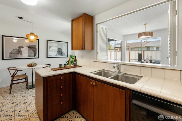 2691 Sean Ct, South San Francisco, CA 94080 - kitchen featuring black dishwasher, a sink, tile countertops, a peninsula, and decorative light fixtures