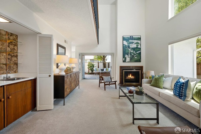2691 Sean Ct, South San Francisco, CA 94080 - living area featuring light carpet, a lit fireplace, a high ceiling, and a textured ceiling