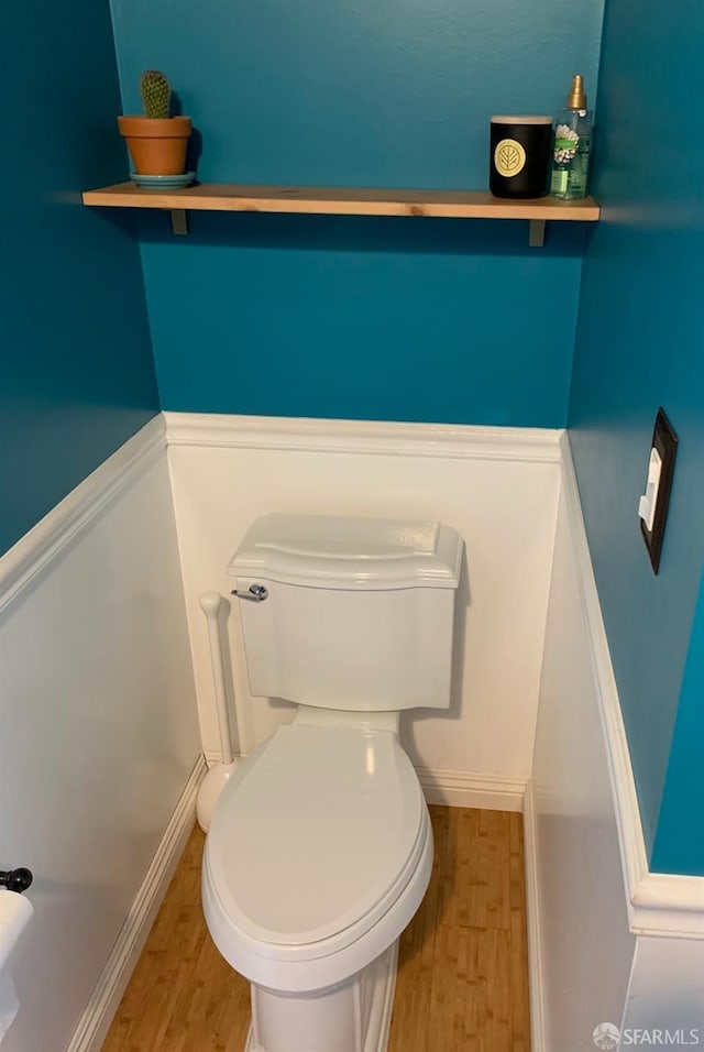 bathroom featuring hardwood / wood-style flooring and toilet