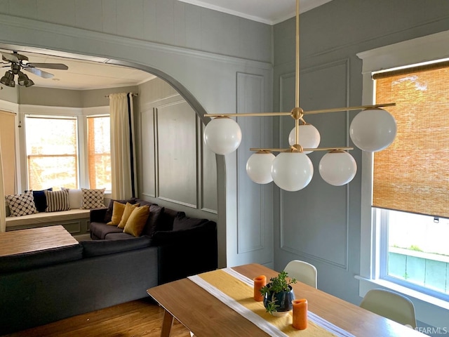 dining room with hardwood / wood-style flooring, crown molding, and a wealth of natural light