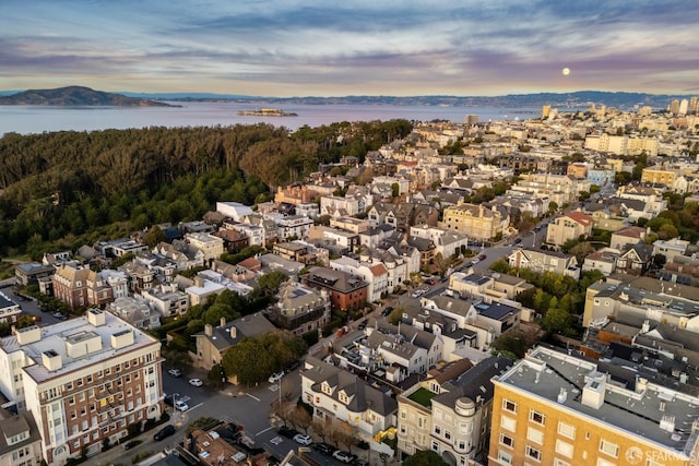 aerial view at dusk with a water and mountain view