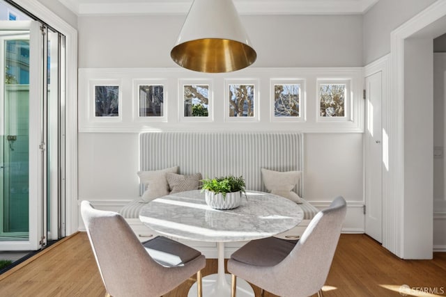 dining room with a wealth of natural light and wood-type flooring