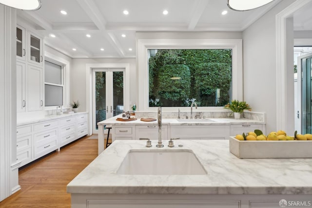 bathroom with french doors, beam ceiling, hardwood / wood-style floors, vanity, and ornamental molding