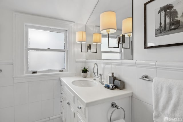 bathroom with backsplash, vanity, and tile walls