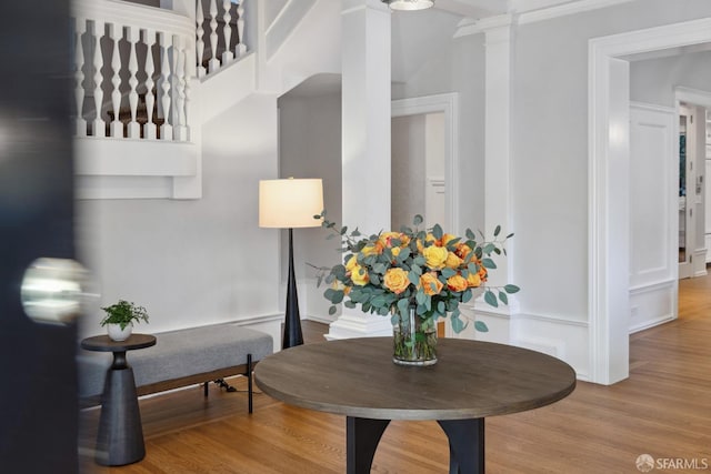 interior details with hardwood / wood-style flooring and ornate columns