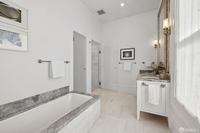 bathroom with sink and plus walk in shower