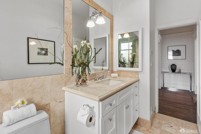 bathroom with an inviting chandelier, vanity, and toilet