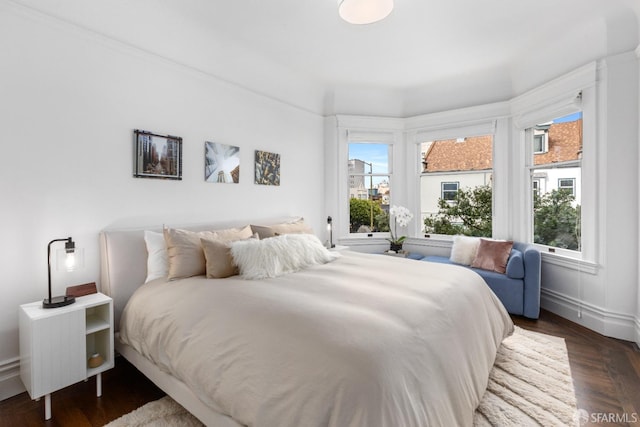 bedroom with dark hardwood / wood-style floors