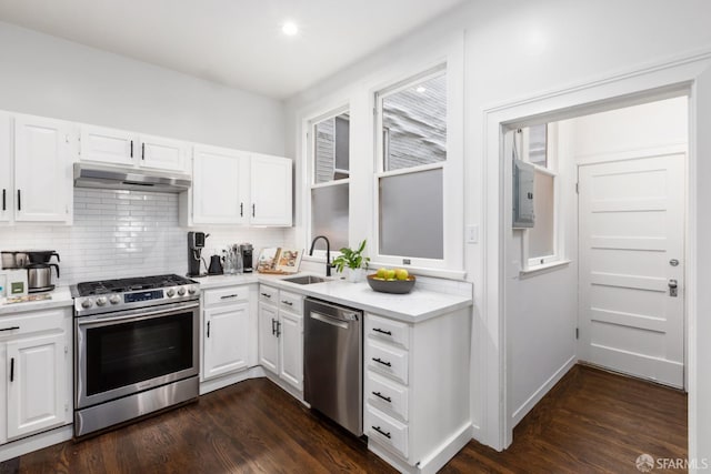 kitchen with white cabinets, dark hardwood / wood-style flooring, sink, and stainless steel appliances