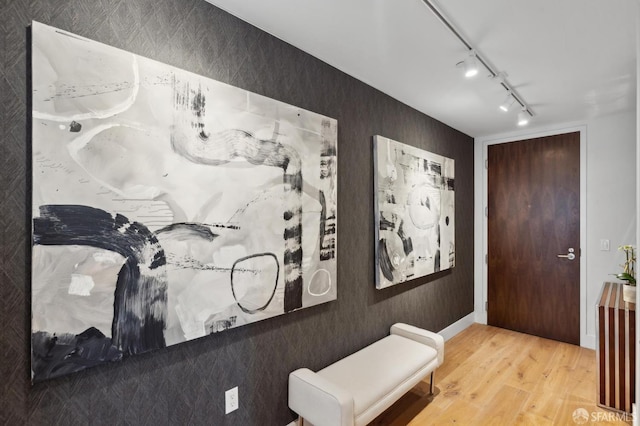 interior space featuring hardwood / wood-style floors and track lighting