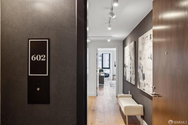 corridor with light hardwood / wood-style flooring