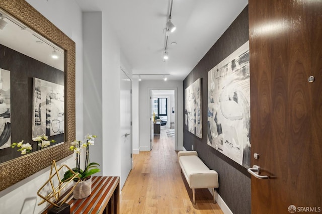 hall with light hardwood / wood-style flooring